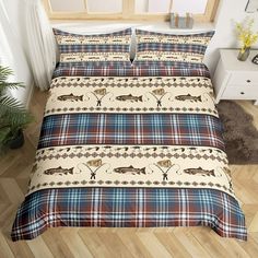 a bed room with a plaid comforter and pillows