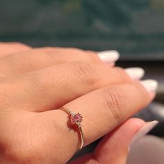 a close up of a person's hand with a ring on it