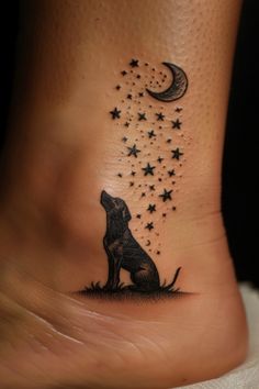 a dog sitting on the ground with stars and a crescent tattoo design on its foot