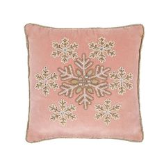 a pink pillow with an embroidered snowflake design on it