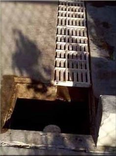 a manhole cover with grates on the ground