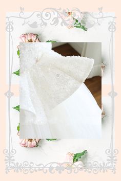 an image of a wedding dress with flowers around it