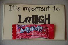 a sign that says it's important to laugh at the candy bar on the fridge