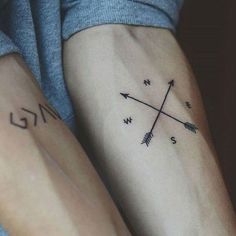 a woman's arm with an arrow tattoo on it