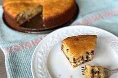 a piece of cake sitting on top of a white plate next to a slice of pie