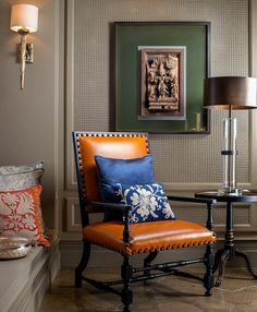 a chair and table in a room with a painting on the wall