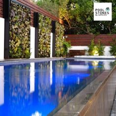 an empty swimming pool surrounded by trees and plants with a sign that reads pool stones