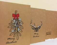 three christmas cards with antlers and bows on them