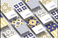 an array of blue, yellow and white cards with geometric designs on them that spell out the word happiness