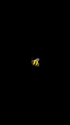 a bee flying in the dark with its head turned to the side and eyes closed