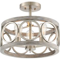 the light fixture is made from wood and has round metal details on each end, with two