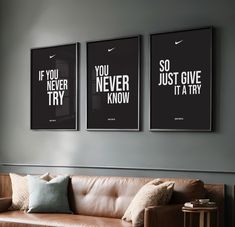 three black and white posters hanging on the wall above a brown couch in a living room