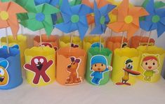 there are many paper bags with cartoon characters on them and some pinwheels sticking out of them