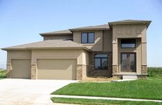 a two story house with grass in the front yard