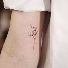 a small flower tattoo on the left side of the leg is shown in black and white