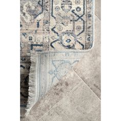 an area rug with various colors and patterns on it, including blue and beige tones