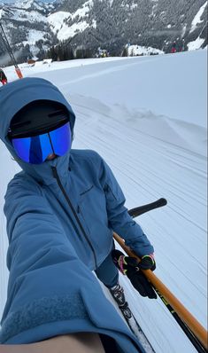 a person with skis and goggles on in the snow