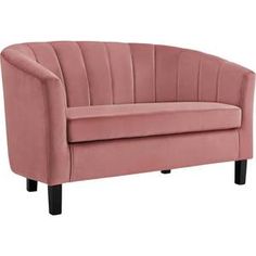 a pink velvet chair with black legs