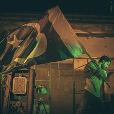 a man holding a flag in front of a camera