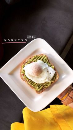 a plate with an egg and avocado toast on it