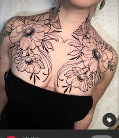 an image of a woman with flowers on her chest that is covered in black ink