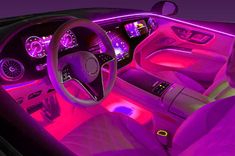 the interior of a car with purple lighting