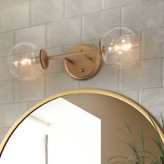 two lights on the wall above a mirror