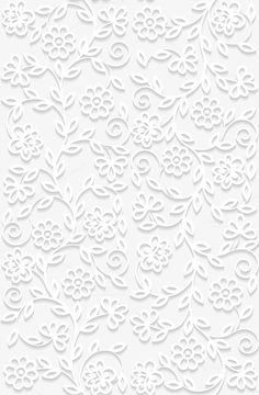 a white paper cutout with flowers and swirls on the bottom, in an intricate pattern