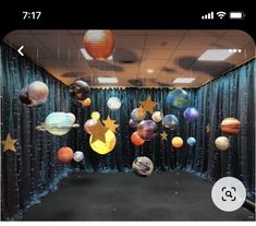 an office cubicle decorated with balloons and stars