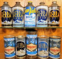 several cans of beer are lined up on a shelf