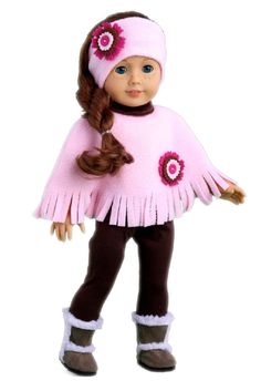 a doll wearing a pink ponchy and brown pants