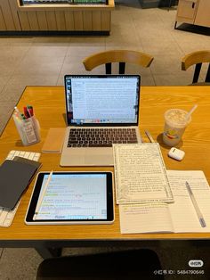 an open laptop computer sitting on top of a wooden table