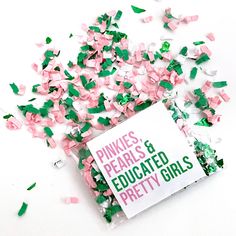 pink, green and white confetti sprinkles on top of a book