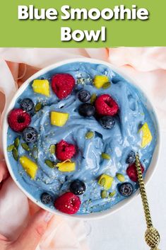 blue smoothie bowl with berries and raspberries in it