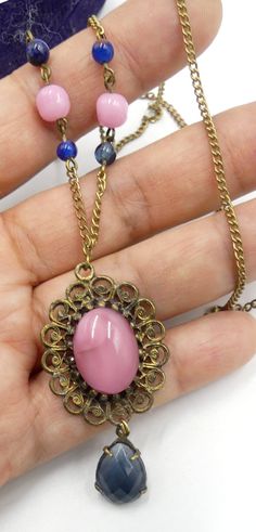 "Vintage brass chain and pink blue glass cabochon pendant necklace, In good vintage condition. Necklace 23\" long. Pendant 2\" x1\". Pink beads 7 mm. Blue beads 4 mm. Pink cabochon 17 mm x 13 mm. Blue cabochon 15 mm x 10 mm. Thanks." Victorian Pendant Necklace With Cabochon, Pink Vintage Charm Pendant Jewelry, Pink Cabochon Necklaces For Gift, Vintage Brass Necklaces With Cabochon, Swarovski Brooch, Vintage Blue Glass Necklace, Sterling Silver Marcasite, Cabochon Pendant, Long Pendant