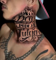 a man with tattoos on his neck is wearing a baseball cap and chain link necklace