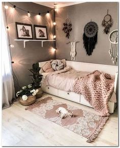 a bedroom with lights strung from the ceiling and rugs on the floor in front of the bed