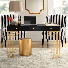 black and white striped chairs in front of a desk with a laptop on top of it