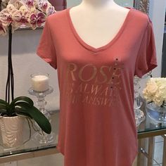 Super Soft Short Sleeve T-Shirt With Gold Lettering That Says Rose Is Always The Answer. This T-Shirt Is So Soft. I Have The Exact Same Shirt But In Small. This One Is A Medium. New With Tags And Has Never Been Worn. The T-Shirt Is A Little Bit On The Long Side. I Would Say It Kind Of Goes Past The Hips At Least On Me. I’m Not Very Tall. Gorgeous Dusty Rose Color. Gold Lettering. V-Neck. The Fabric Is Super Soft. And Rose Is Always The Answer For Everything!. Non-Smoking Household Fast Shipper Rose Print Tops For Summer, Casual Rose Print Tops In Rose Color, Casual Rose Cotton Top, Casual Rose Print Tops, Summer Graphic Tee With Rose Print, Rose Color Crew Neck Top With Rose Print, Short Sleeve Rose Print Graphic Tee Tops, Casual Pink T-shirt With Rose Print, Casual Pink Rose Print T-shirt