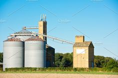 two silos in front of an old grain mill