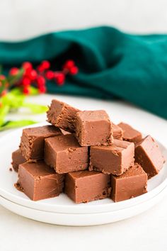 a white plate topped with chocolate fudges on top of a table next to a green napkin