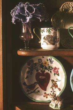 plates and vases are sitting on a shelf