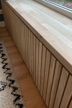 a window sill sitting on top of a wooden floor