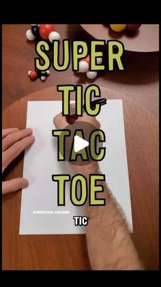 someone is writing on paper with the words super tic tac toe in front of them