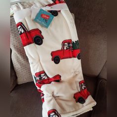 a red truck blanket sitting on top of a couch