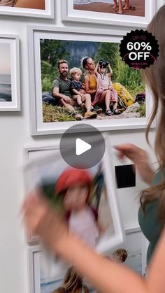 a woman is looking at pictures on the wall