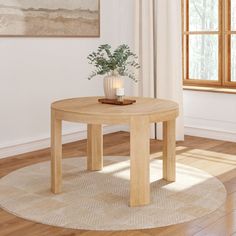 a round table with a plant on it in front of a window and wooden floor