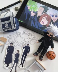 an image of anime character paper dolls next to a bag and some other items on a table