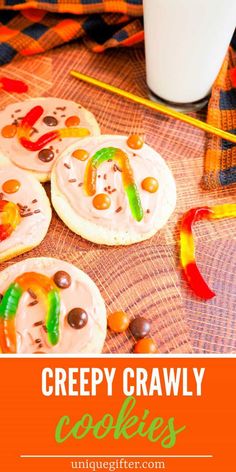 some cookies with candy on them and the words creepy crawly cookies