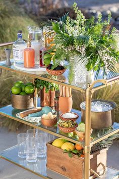 an outdoor bar cart filled with drinks and food